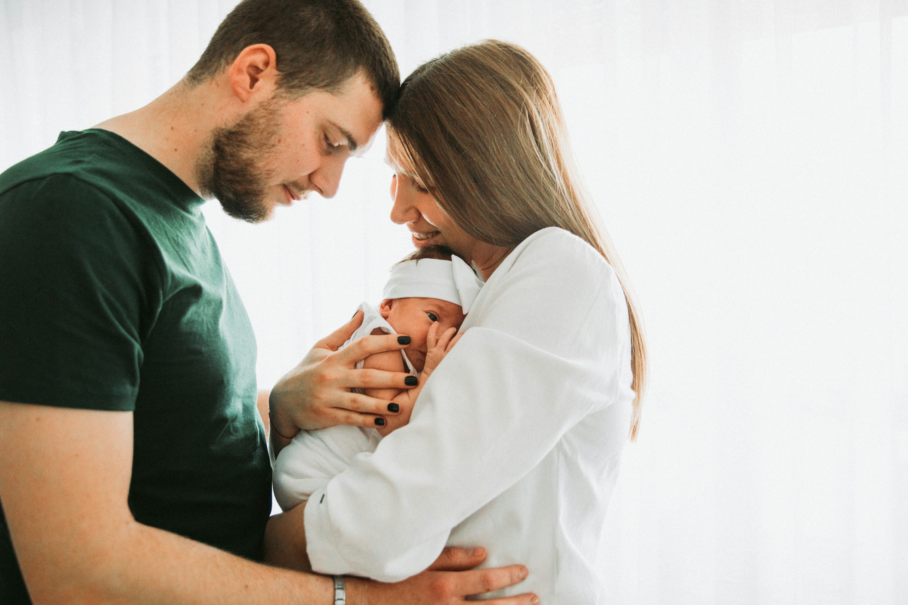 Parents holding their newborn baby in a quiet moment